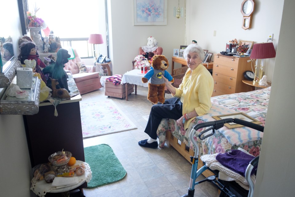 Sadie Lamothe, in her 80s, at her apartment in the Great Northern Retirement Centre. Lamothe clutches a teddy bear wearing a Batman hoodie which she got from a 'giveaway' event put on by local charity-group Sault Ste. Marie Helping Hands. Jeff Klassen/SooToday