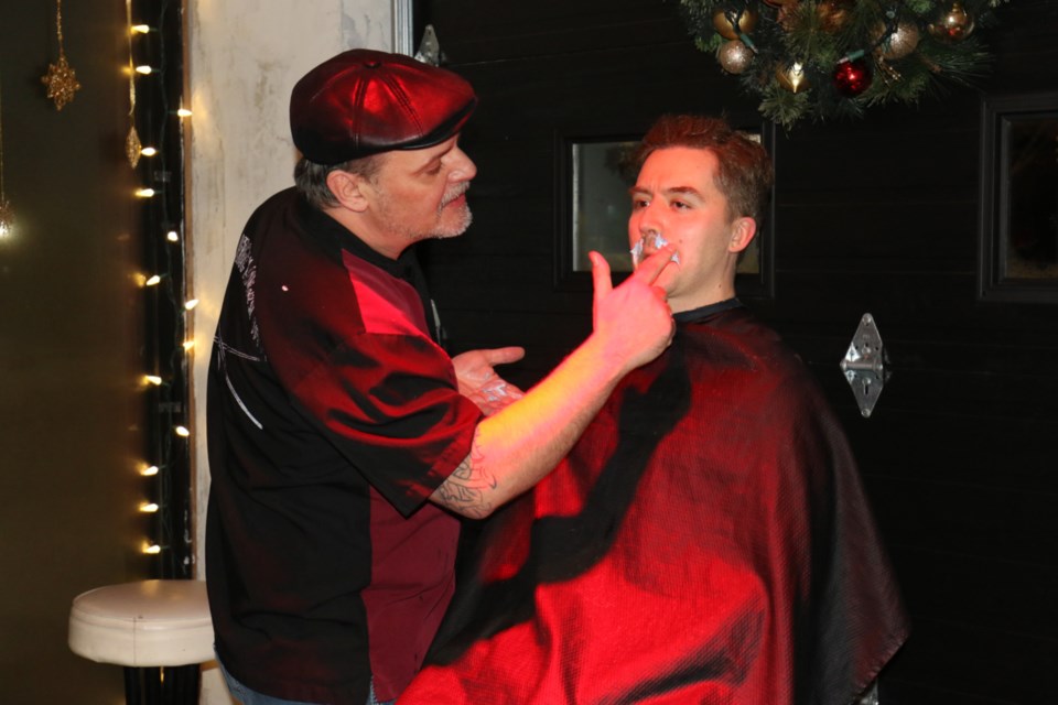 Outspoken Brewing owner and operator Graham Atkinson, right, gets his moustache shaved off by local barber Danny Trevisanut during Saturday's Movember Shave Down Gala at Outspoken Brewing. James Hopkin/SooToday 