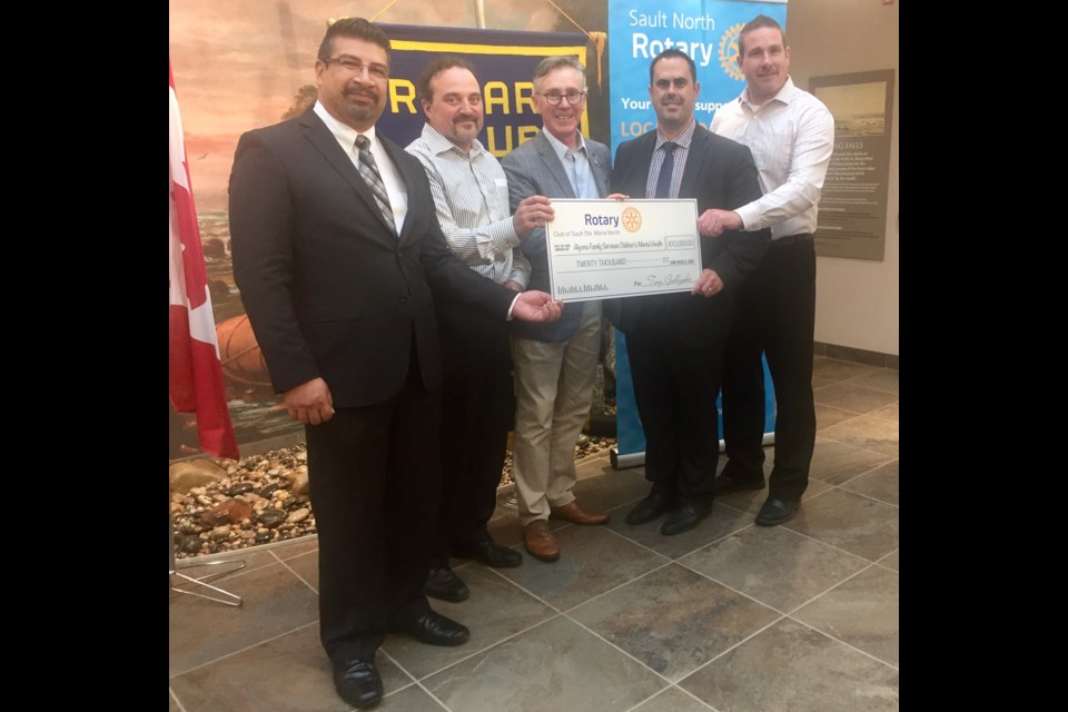 Algoma Family Services Chief Executive Officer Ali Juma (left), foundation President and Vice President Sony Spina and Brad Gregorini (second from right and far right) accept a cheque from incoming Sault North Rotary President Dino Biasucci and outgoing President Tony Gallagher. Carol Martin/SooToday  