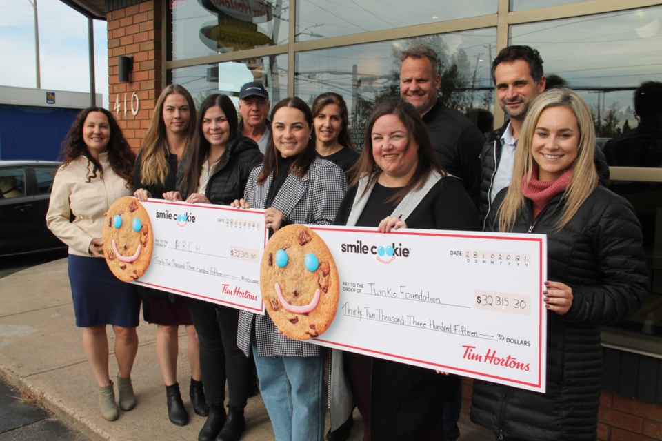 Sault Ste. Marie Tim Hortons franchisees, along with  ARCH and Twinkie Foundation representatives, gathered at the McNabb and Pine Street Tim Hortons location where Tim Hortons presented over $32,000 to each of those organizations in support of their community efforts, funds raised through Smile Cookie sales, Oct. 28, 2021. Darren Taylor/SooToday 