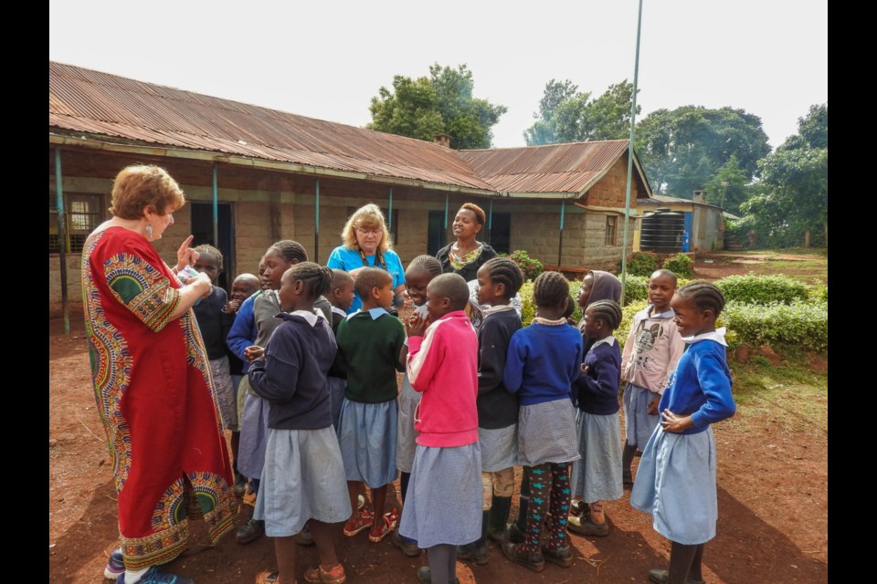 Tumaini Afrika members Holly Wickett, Micheline Findlay and Flora Nduge with Kenyan school children.