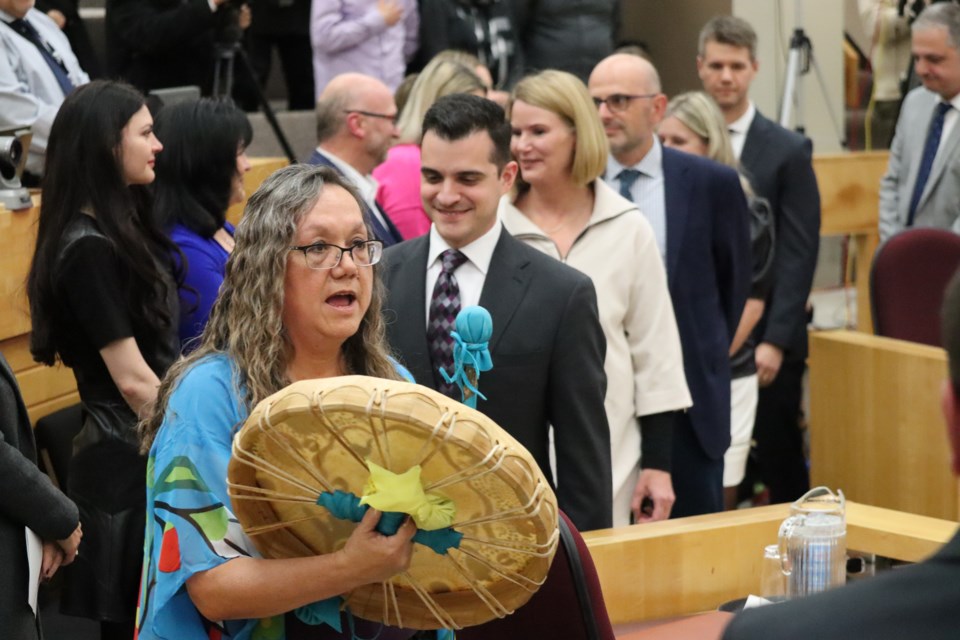 Matthew Shoemaker and his 10 councillors-elect are drummed into the council chambers by a member of the Healing Lodge Singers.
