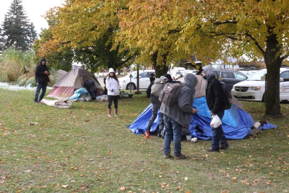 People tear down tents outside Ronald A. Irwin Civic Centre Wednesday. 