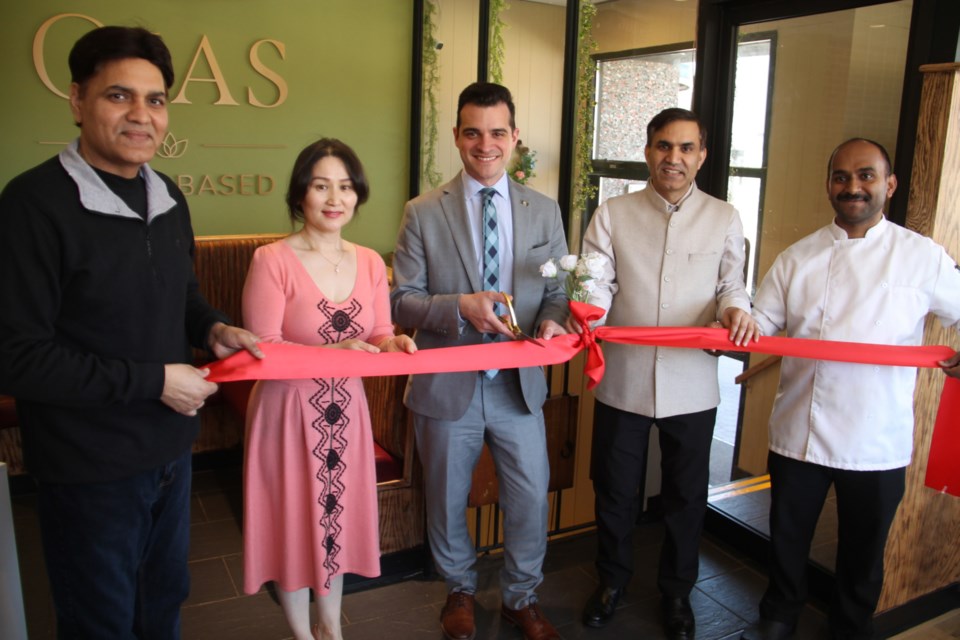 Sault Mayor Matthew Shoemaker cuts the ribbon for Ojas, a new plant-based South Asian eatery with Sundar Singh, co-owners Oyunbileg Chuluunbazar (Oyuna) and Surendra Kumar Bansal (Kumar) and chef George Madickankel, April 25, 2024.