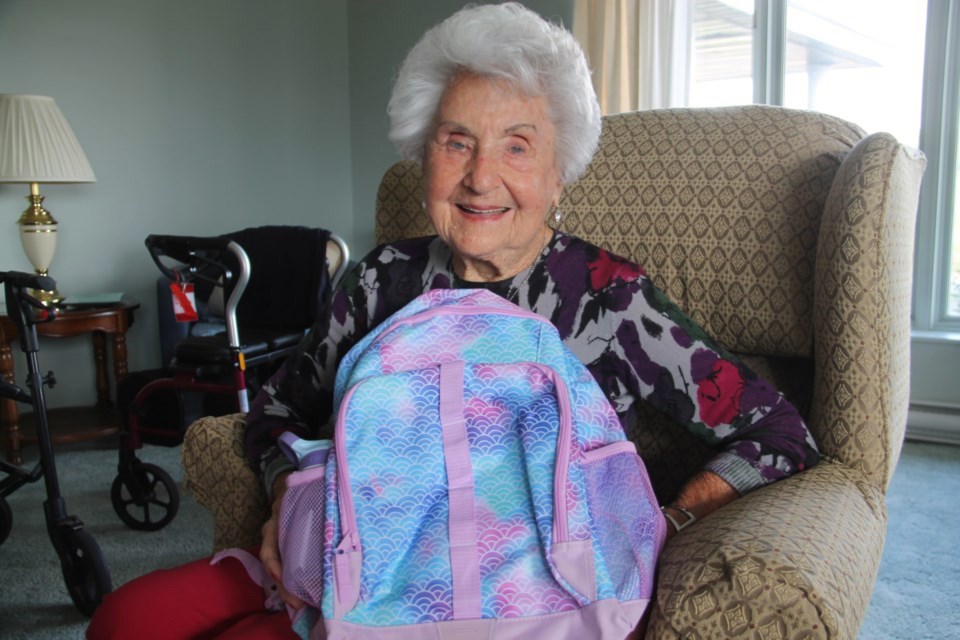 Reva Ovens, Pathways Retirement Residence resident with a new backpack filled with back to school supplies for needy children, Aug. 25, 2023.