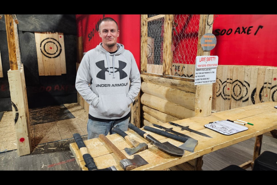 Brad Collar, Soo Axe Throwing owner with a selection of axes and knives, April, 5, 2025.