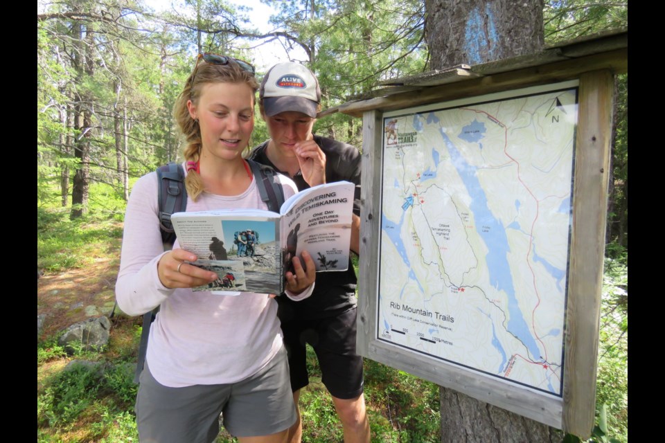  Ali and Mike look at the orientation map at the top of Cliff Lake this is a day trip paddle and hike adventure.