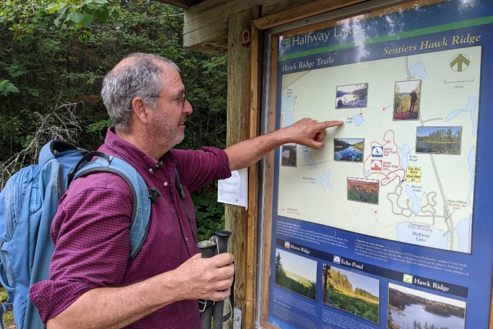 Bernie Moseley-Williams checks out the Earth, Wind and Fire theme at Halfway's trailhead sign. 