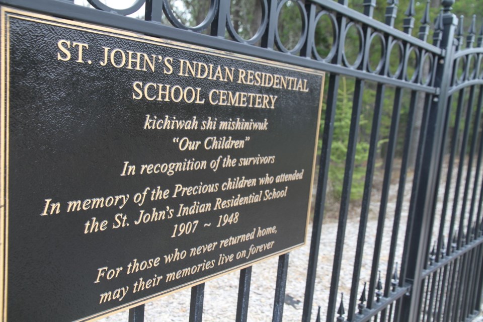 Behind this fence on the side of a hill, you will find the graves of the many children buried. 