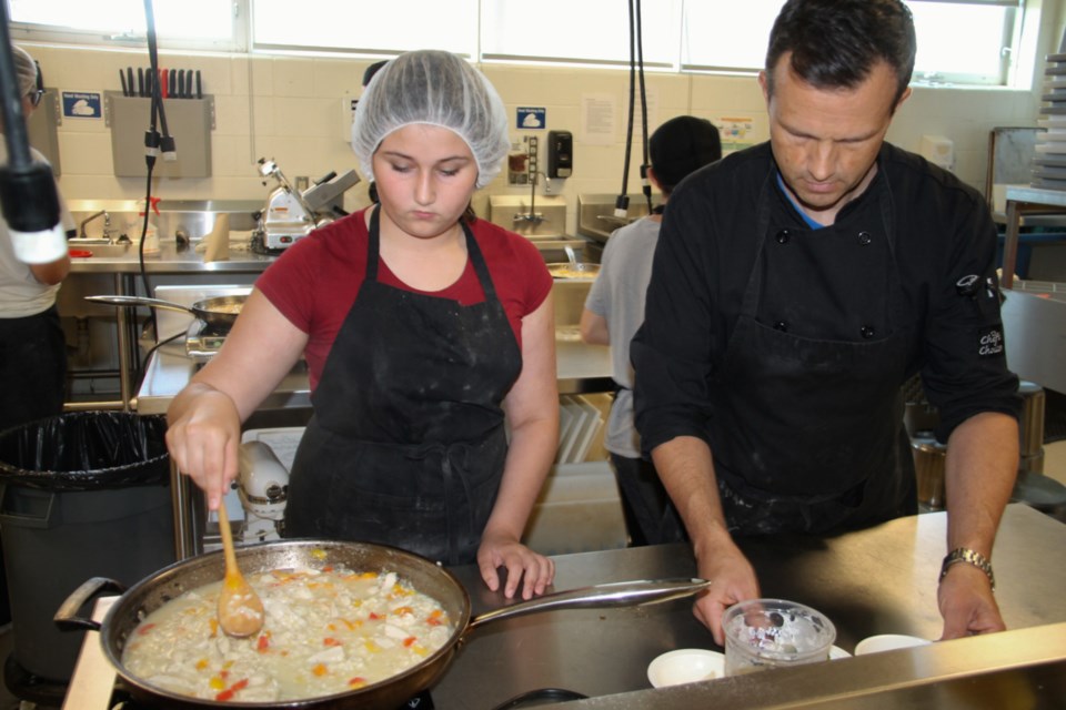 Lily Faubert, culinary arts summer school student, and Jason Zachary, culinary arts teacher, prepare lunch at Superior Heights Collegiate, July 17, 2019. Darren Taylor/SooToday
