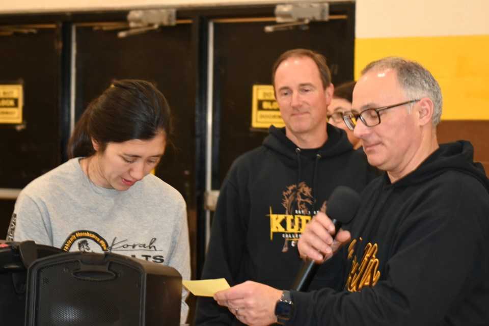 Kim Policicchio, Korah Collegiate teacher, Tony Schoahs, Korah vice principal and Steve Caruso, Korah principal drawing the winning ticket at the school’s annual Super Bowl Draw, Jan. 19, 2024.