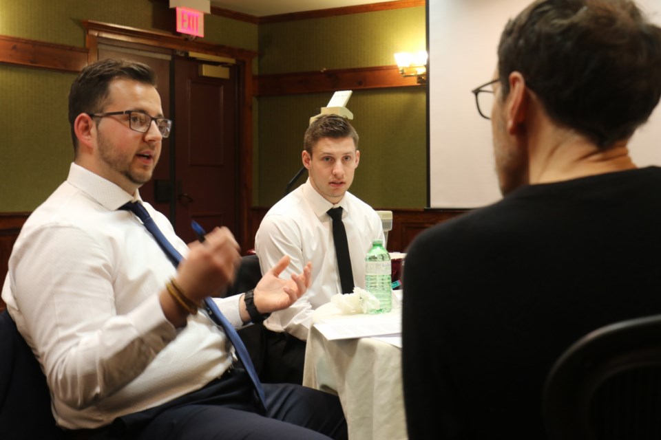 Paolo Bruni, left, and Nic Tassone, middle, get some advice from Porter Airlines marketing director Michael Macaulay during the Northern Ontario Business Case Competition at the Water Tower Inn on Wednesday. James Hopkin/SooToday