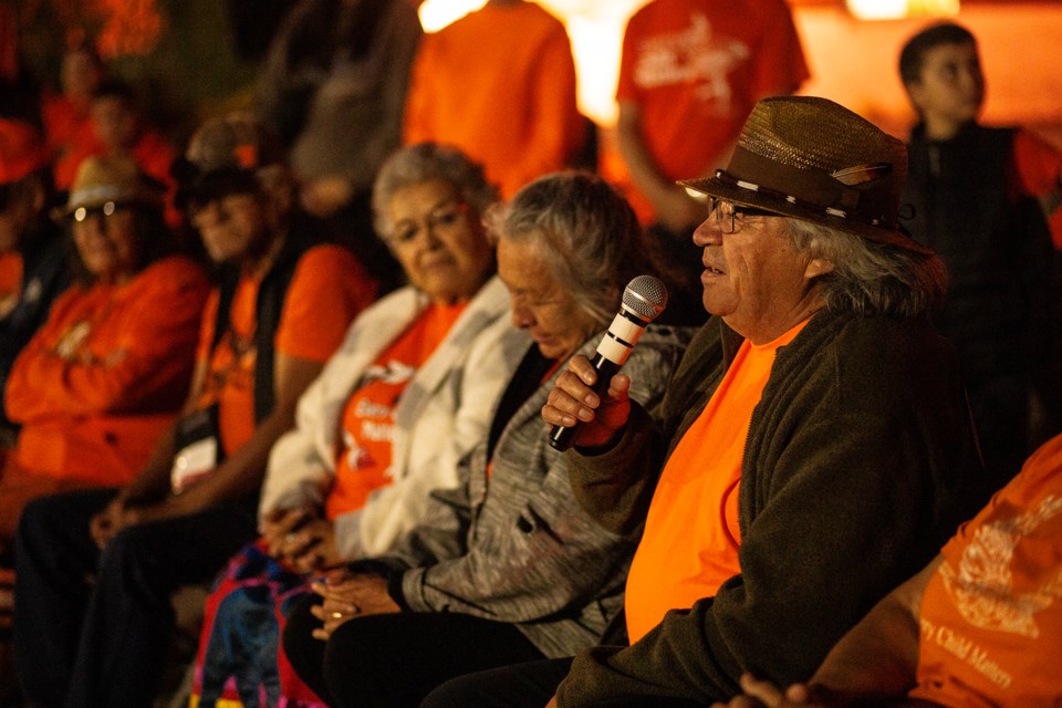 Residential school survivor George Diamond speaks during a candlelight vigil marking Orange Shirt Day on Monday evening at Algoma University. Diamond said the three residential schools he attended tried to take his language away, but were not successful. He said his 13 grandchildren all speak Cree.