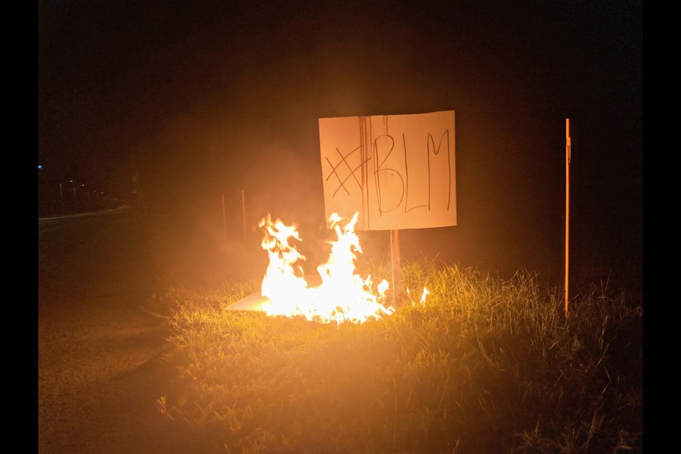 Black Lives Matter signs burning early Monday morning in front of Algoma University. Carol Martin/SooToday