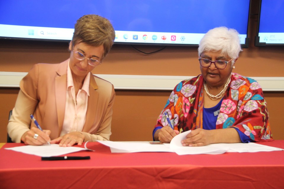Asima Vezina, Algoma University president and Dr. Sarita Verma, NOSM University president sign an agreement designed to lead to the establishment of a Mental Health Research and Training Institute at Algoma University, July 26, 2023.
