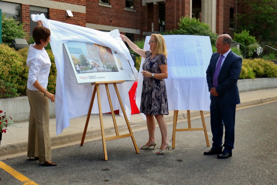 Algoma University president Asima Vezina, School of Business and Economics director Cathy Denomme and board of governors chair Mark Nogalo unveil conceptual drawings for the university's new School of Business & Economics Tuesday. James Hopkin/SooToday