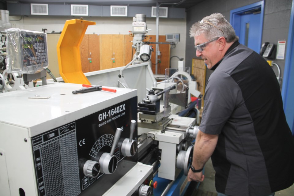 Peter Corbett, Sault College machine shop professor, with new equipment at the college’s machine shop, May 4, 2022.
