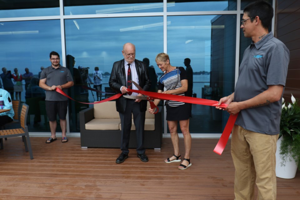 Sault College President Dr. Ron Common and Betty Lou Lukenda cut a ribbon during the grand opening of Sault College's Waterfront Adventure Centre Friday. James Hopkin/SooToday