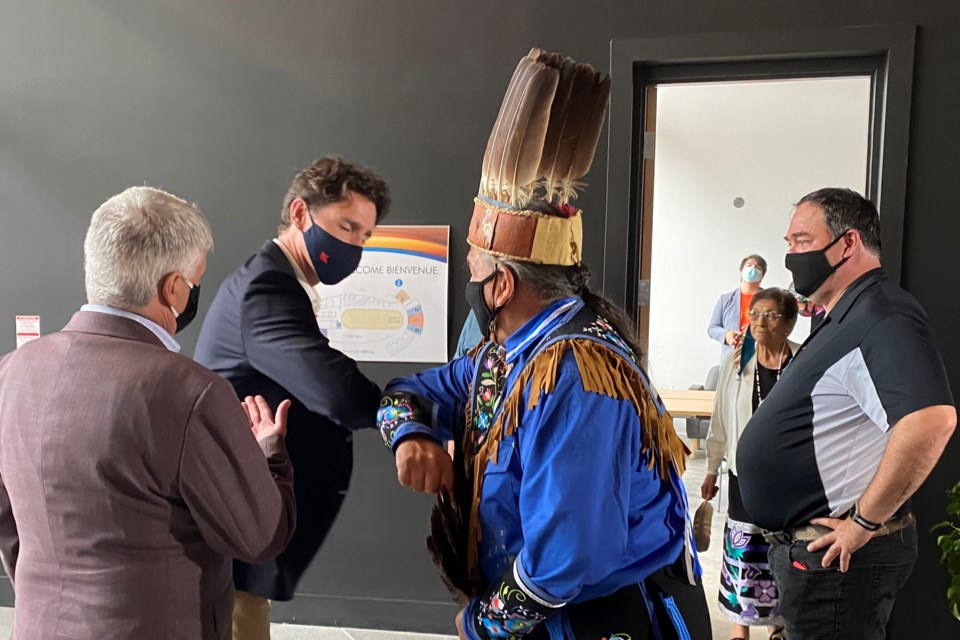 Prime Minister Justin Trudeau elbow-bumps Batchewana First Nation Chief Dean Sayers Monday at Shingwauk Kinoomaage Gamig Centre of Excellence in Anishinaabe Education, as Sault MP Terry Sheehan looks on (from left)