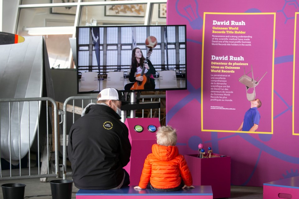 Visitors to the Canadian Bushplane Heritage Centre watch an interactive display as part of the travelling Guinness World Records exhibit.
