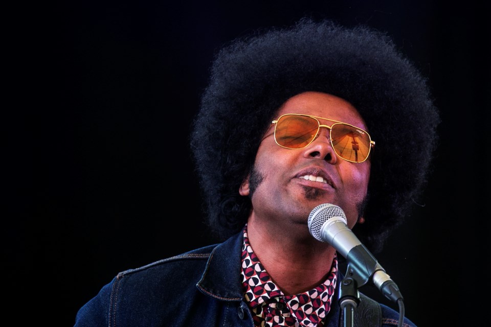 Rigging for the Roberta Bondar Pavilion is reflected in the glasses of Alex Cuba during a performance at the waterfront venue on Wednesday.
