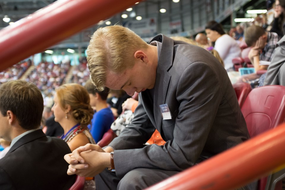 Elijah Turcott from Lakewood prays with around 2300 other faith-followers during the Northern Ontario 2016 Convention of Jehovah's Witnesses held in Sault Ste. Marie. Photo by Jeff Klassen for SooToday