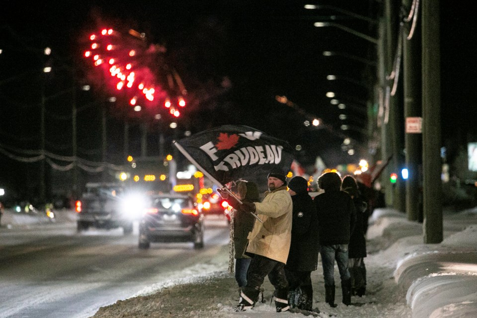 A group of supporters cheer on what's been called the Freedom Convoy 2022 as it enters the Sault on Thursday night with a fireworks display.