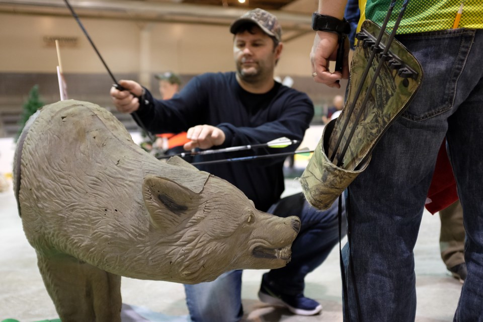 Archers retrieve their arrows at Sault North Archery Club's Spring Fling 3D indoor archery event on Saturday.  Photo by Jeff Klassen for SooToday