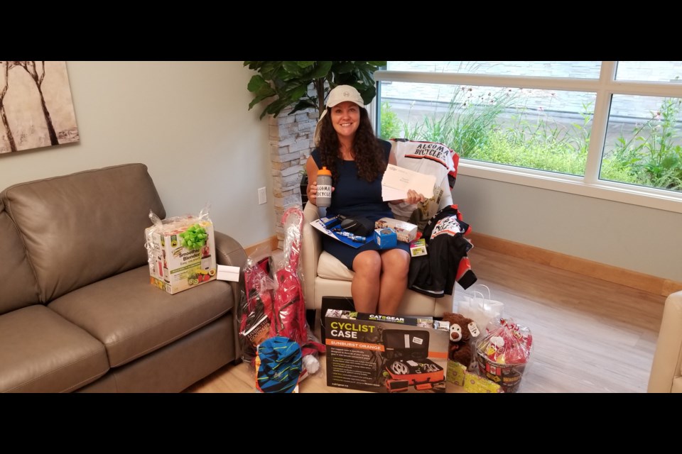 Julie Premo with just some of the amazing prizes cyclists can win at the Great Bucket List Cycle thanks to the generosity of local businesses. Sandi Wheeler/SooToday