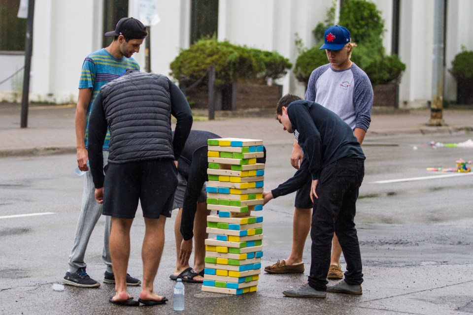The rain didn't deter some diehards from enjoying the games and activities during the Downtown Street Party on Queen Street on Thursday, July 14, 2016. ©Donna Hopper/SooToday