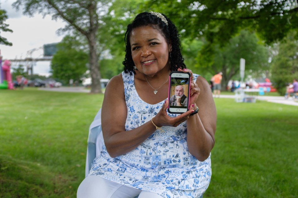 Sally Toivonen holds up a picture of her recently deceased husband Allan Toivonen. While Allan spent his last days at ARCH Hospice, his singing group Northland Barbershop Chorus, came and did a special performance for him. Jeff Klassen/SooToday