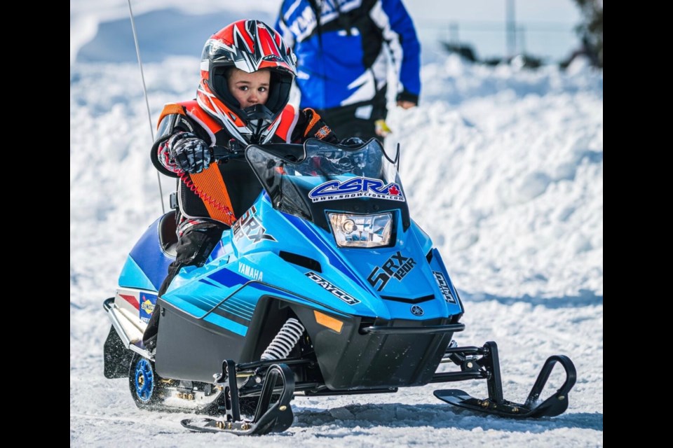 A young snowmobile rider.