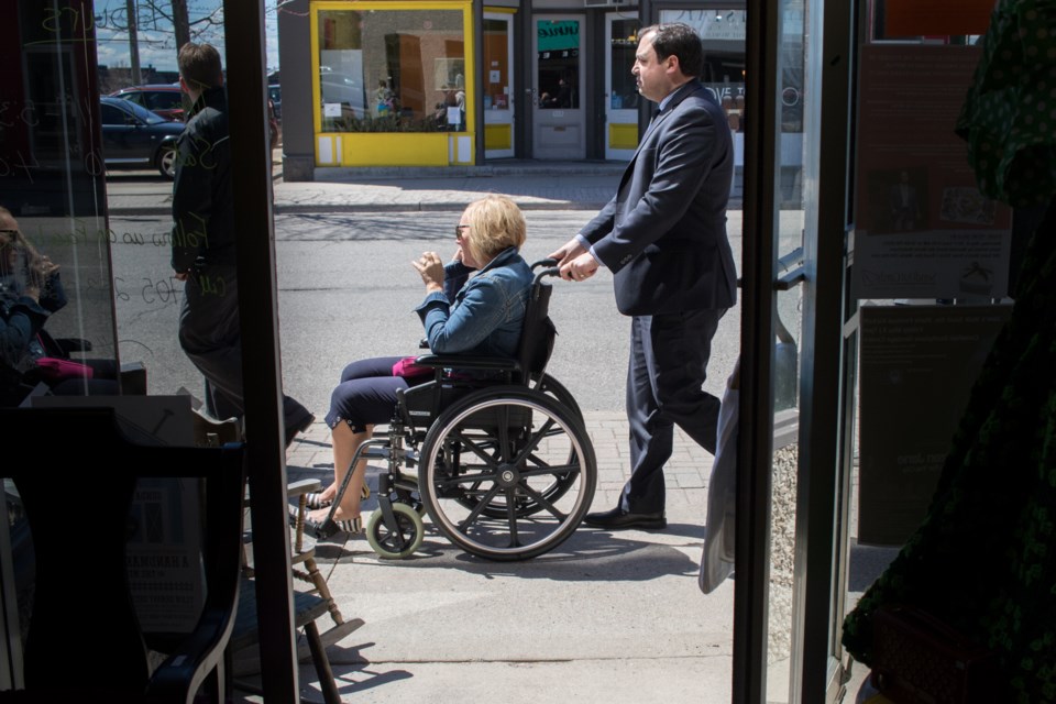 Mayor Christian Provenzano pushes a person in a wheelchair along Queen Street during the Accessibility in Downtown Sault Ste. Marie Walk as part of the 2017 Jane's Walk Sault Ste. Marie multi-tour event. Event organizers invited users to sit in and push wheelchairs so they could get a better understanding of the mobility issues some people face downtown. Jeff Klassen/SooToday