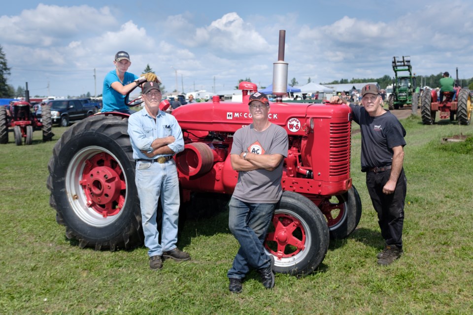 Since around 2000, brothers Jim (centre left), Richard (centre right), and John (right) Grasley have been crazy about antique tractors.  The brothers competed at the 2017 Laird Fair Antique Tractor Pull along with John's grandson Mitchell Parr (left). Jeff Klassen/SooToday