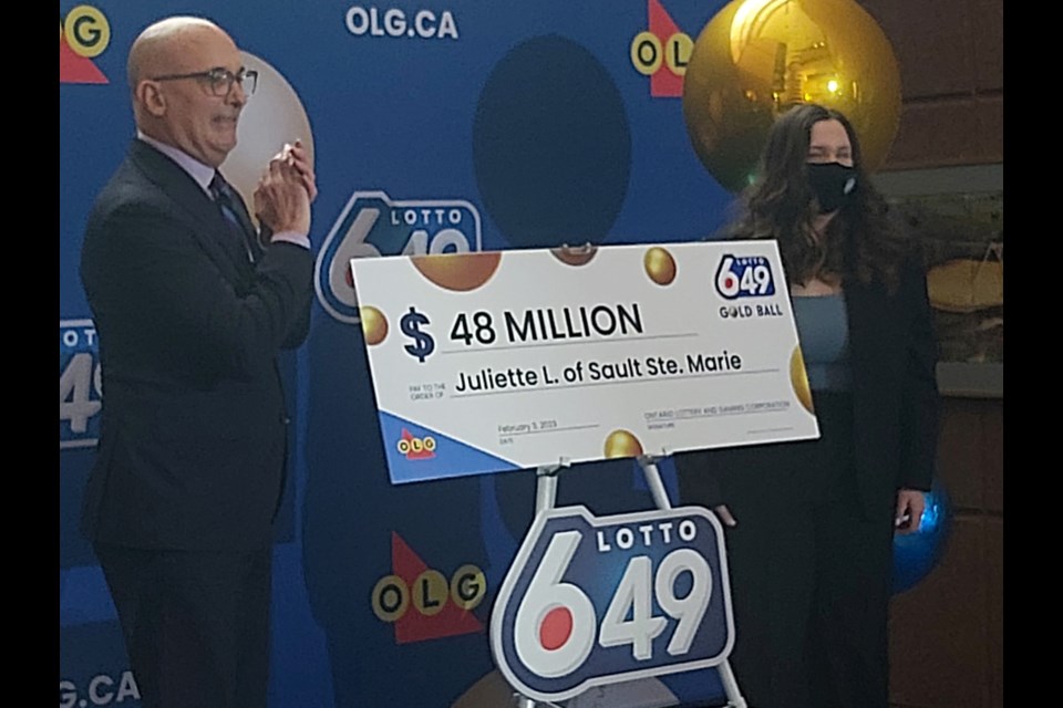 18-year-old Juliette Lamour is presented with her $48-million Lotto 6/49 win by Duncan Hannay, OLG president and CEO at OLG headquarters in Sault Ste. Marie on Friday, Feb. 3, 2023