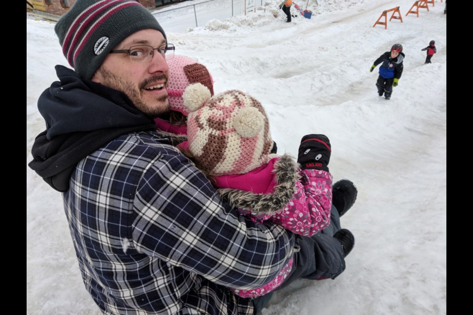 It was more slushy than slippery, but mild weather didn’t stop children and parents from enjoying the Bon Soo Bum Slides outside The Machine Shop, Feb. 1, 2020. The  ever-popular bum slides continue throughout the winter carnival, which wraps up Feb. 9. Darren Taylor/SooToday 