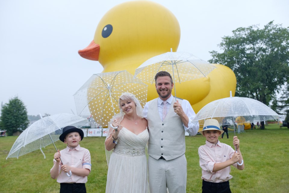 Steph Knight and Todd Knight —
 accompanied by Jonas, 8, (left) and Damian, 10, (right) — posed in front of the World's Largest Rubber Duck a half an hour before the couple were to be married on Thursday. Jeff Klassen/SooToday