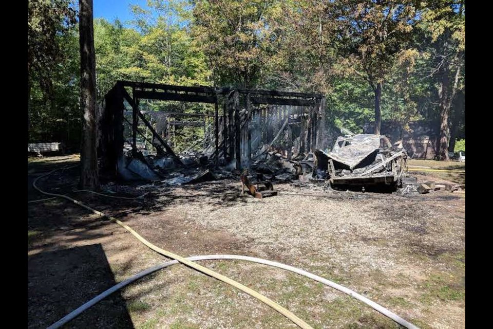 The remains of a garage and vehicle following a fire Thursday afternoon on Ironside Drive in Prince Township. Darren Taylor/SooToday