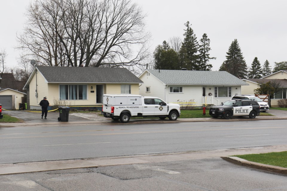 The Ontario Fire Marshal and Sault Ste. Marie Police Service investigate the scene of a house fire in the 200 block of McNabb Street Monday. 