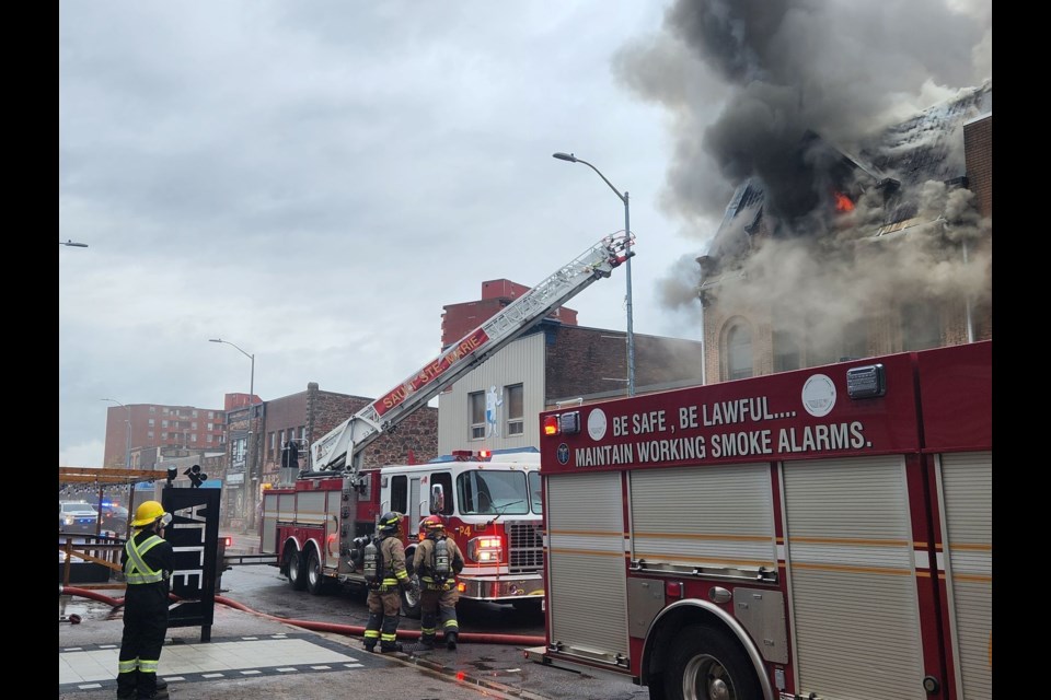 Firefighters douse a fire at 647 Queen Street East on Wednesday, May 8, 2024