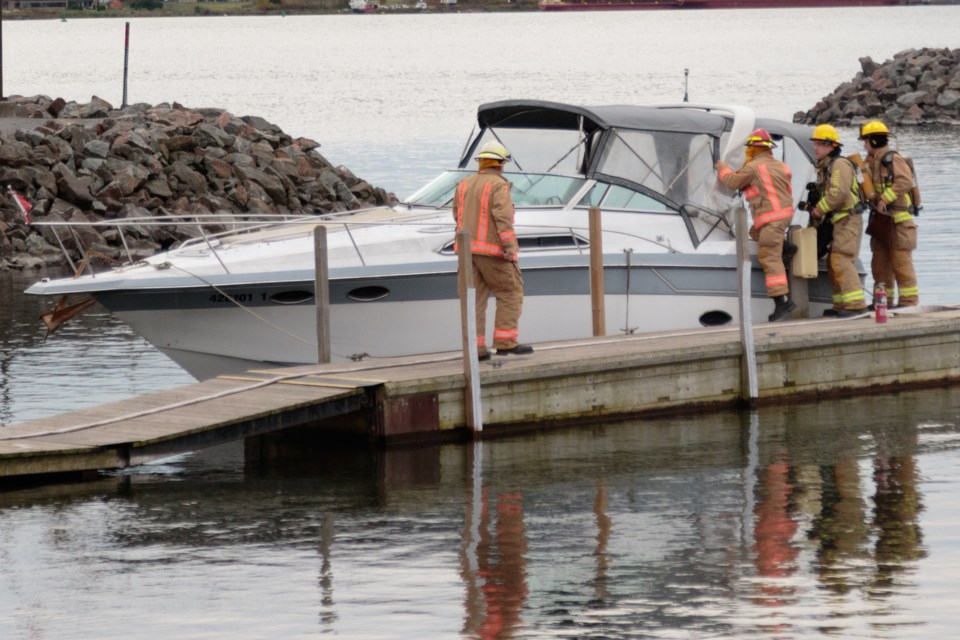 Firefighters responded after a 33-foot pleasure boat carrying multiple persons on the St. Mary’s River started smoking and was driven to shore this afternoon. Jeff Klassen/SooToday