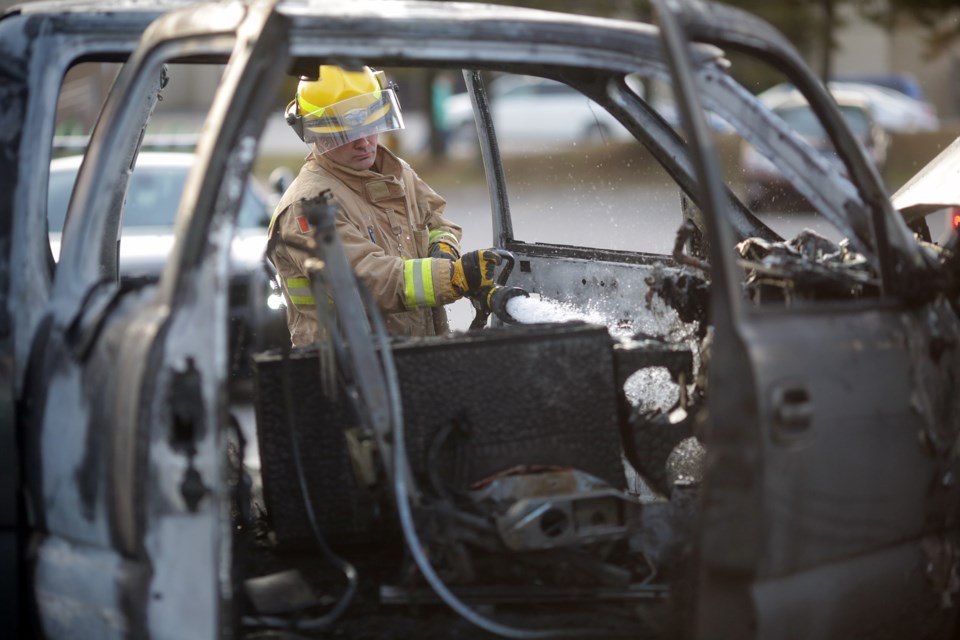 A firefighter dowses the interior of a pickup truck which caught fire tonight in the parking lot of the Roberta Bondar Pavilion. Kenneth Armstrong/SooToday