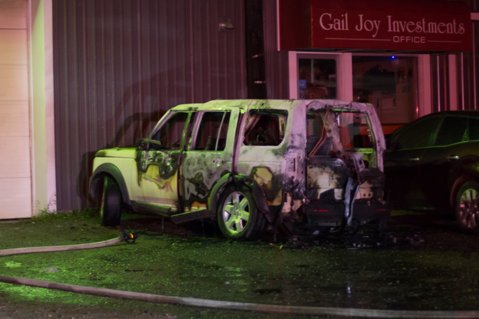 At around 1:15 a.m. last night, an SUV in the parking lot of auto repair business Gail Joy Investments was on fire and put out by Sault Ste. Marie Fire Services. Photo by Jeff Klassen for SooToday