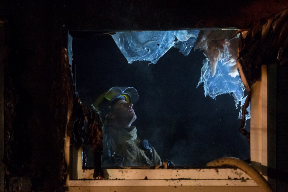 A firefighter seen examining the interior of a house on Labelle Avenue in the aftermath of a house fire on January 15, 2017. Kenneth Armstrong/SooToday