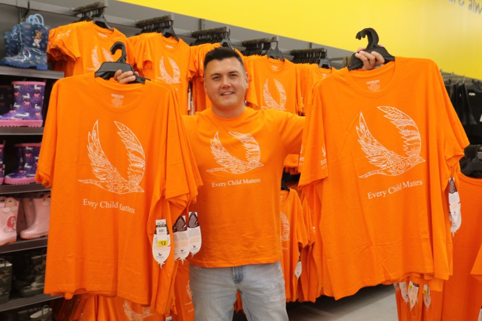 Two-spirited Ojibway artist Patrick Hunter was on hand at the Giant Tiger in Sault Ste. Marie Wednesday to speak with customers about the orange shirt he designed in collaboration with the retail chain as part of a fundraiser for national Indigenous charity Indspire. 