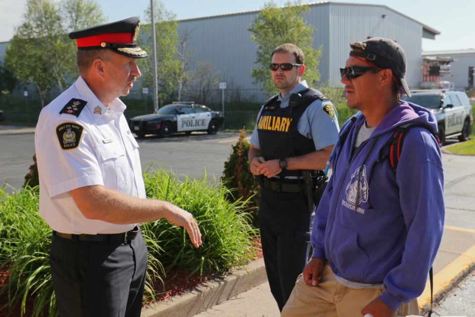 Sgt. Kevin Redsky of the Anishinabek Police Service visits with Sault Ste. Marie Police Service Chief Hugh Stevenson Thursday. James Hopkin/SooToday