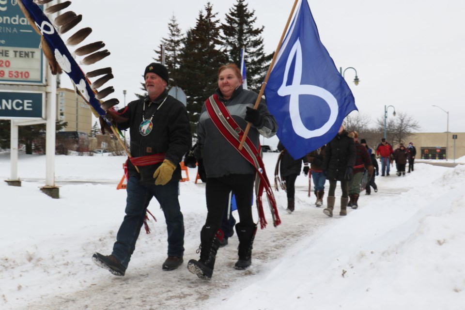 Historic Sault Ste. Marie Metis Council Chair Steve Gjos, left, and president Kim Powley lead members of the Metis community to city hall in order to raise the Metis Nation of Ontario flag in hnour of Louis Riel Day. James Hopkin/SooToday