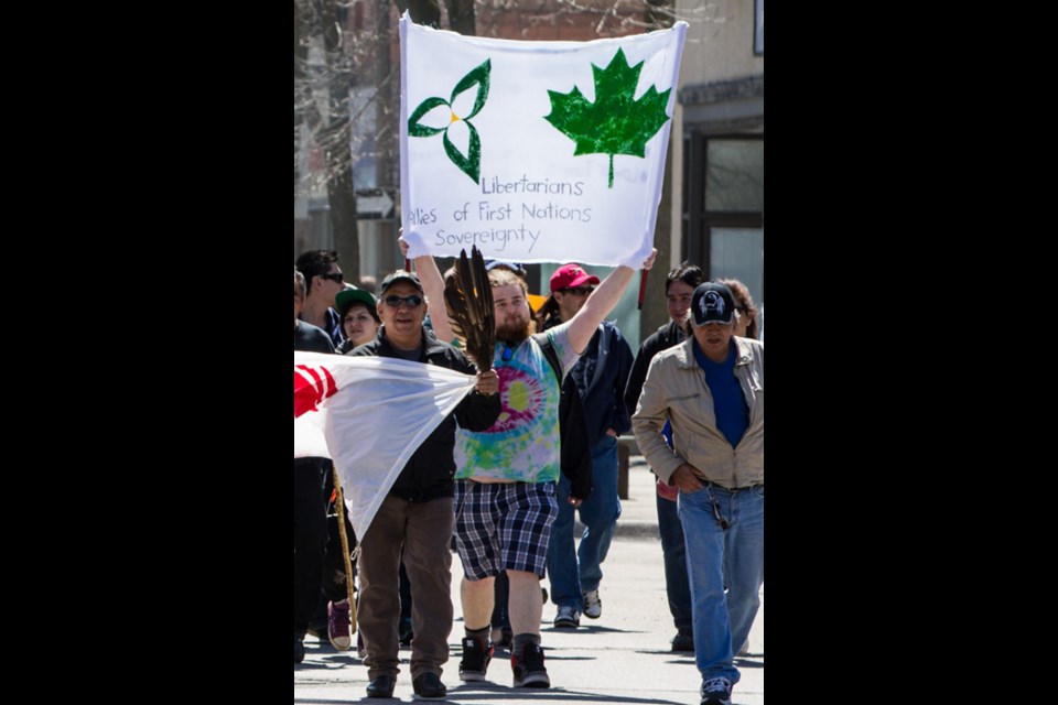 Dozens marched along Queen Street to the Sault Ste. Marie Court House on National Day of Resistance, Wednesday, May 14, 2014. Local Libertarian candidate, Austin Williams showed his support during the rally.