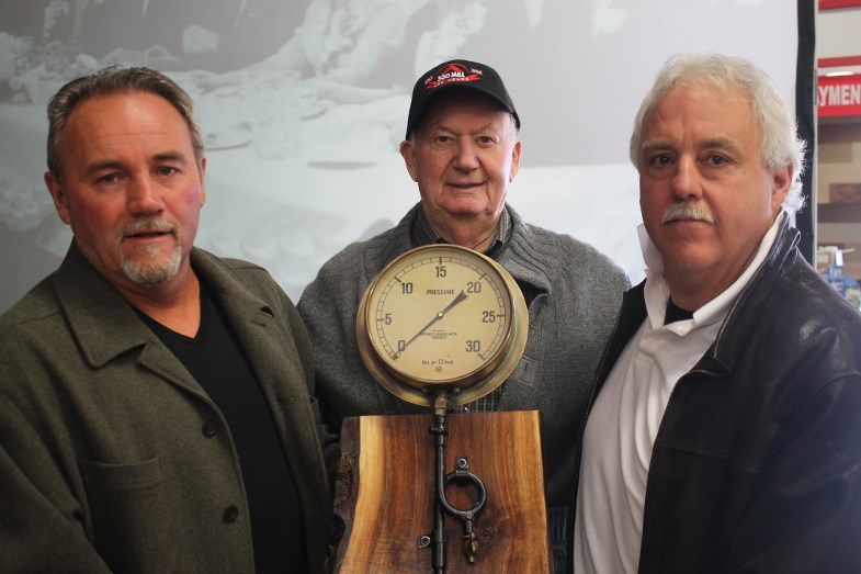 Vic and Rod Fremlin present an old pressure gauge from the old mill as a gift to Ian Hollingsworth. Darren Taylor/SooToday