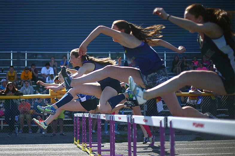 Athletes compete in a girls 80 meter hurdle event during NOSSA Track and Field May 28, 2014. SooToday.com/Kenneth Armstrong